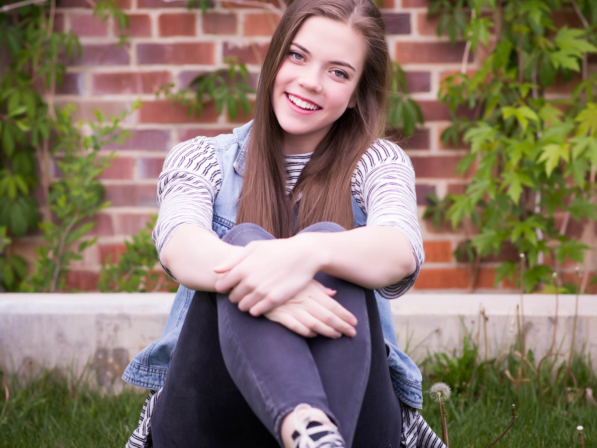 Girl Smiling In The Grass